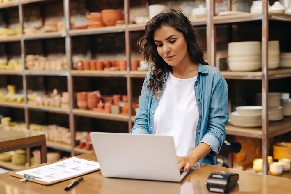 woman working on laptop in craft store