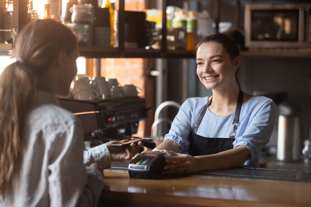 Woman swiping card at POS System