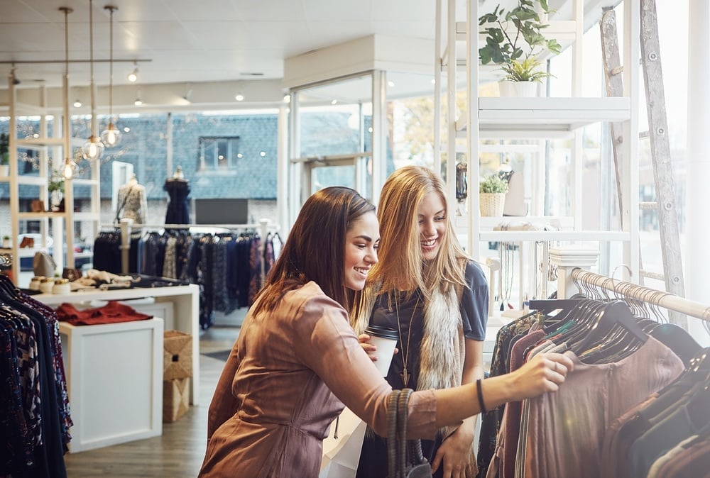 two young women shopping in a clothing boutique